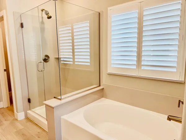 a bathroom with a tub and a shower