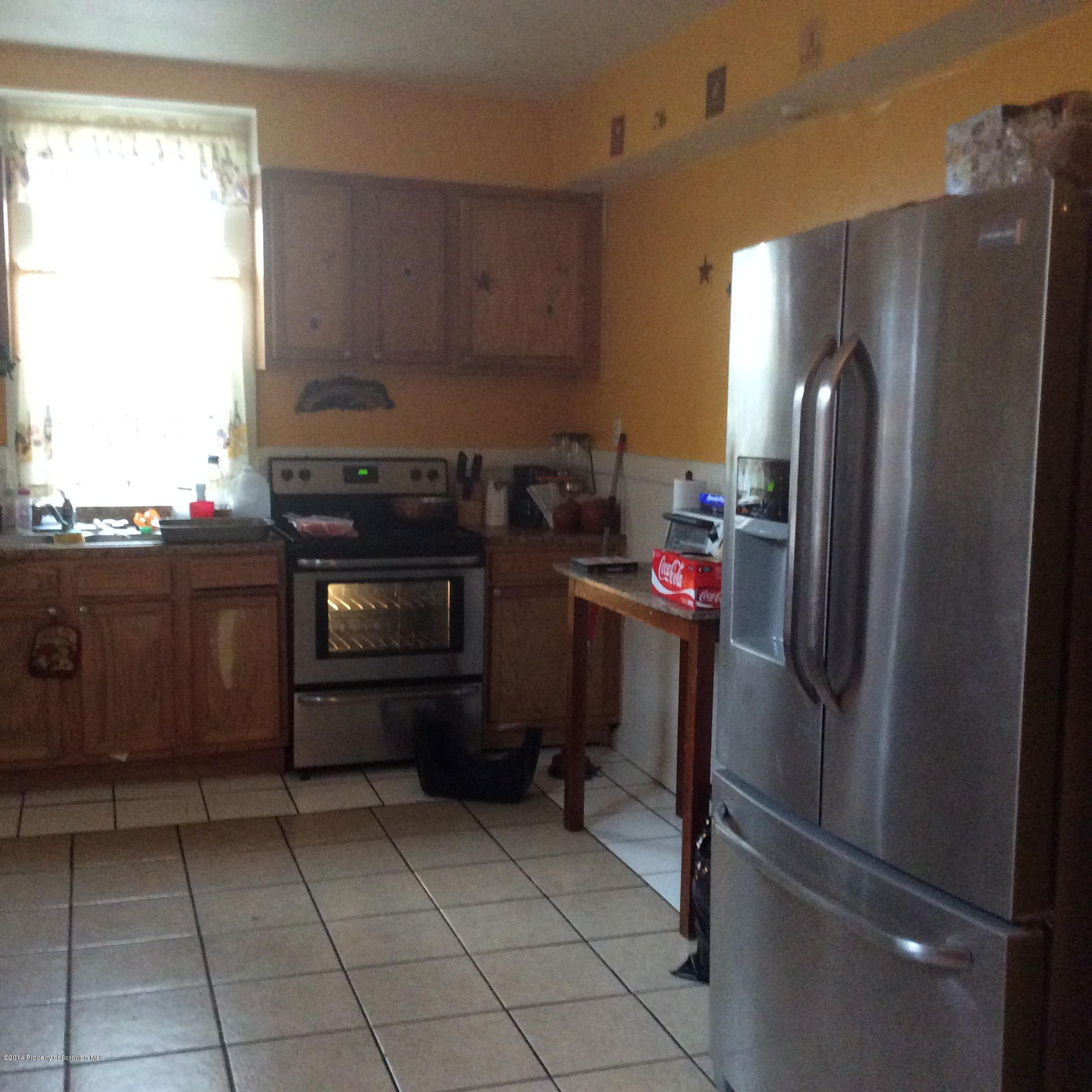 612 Green Ridge Street Scranton, PA 18509 - Photo 8 of 23 a kitchen with granite countertop a refrigerator and a stove