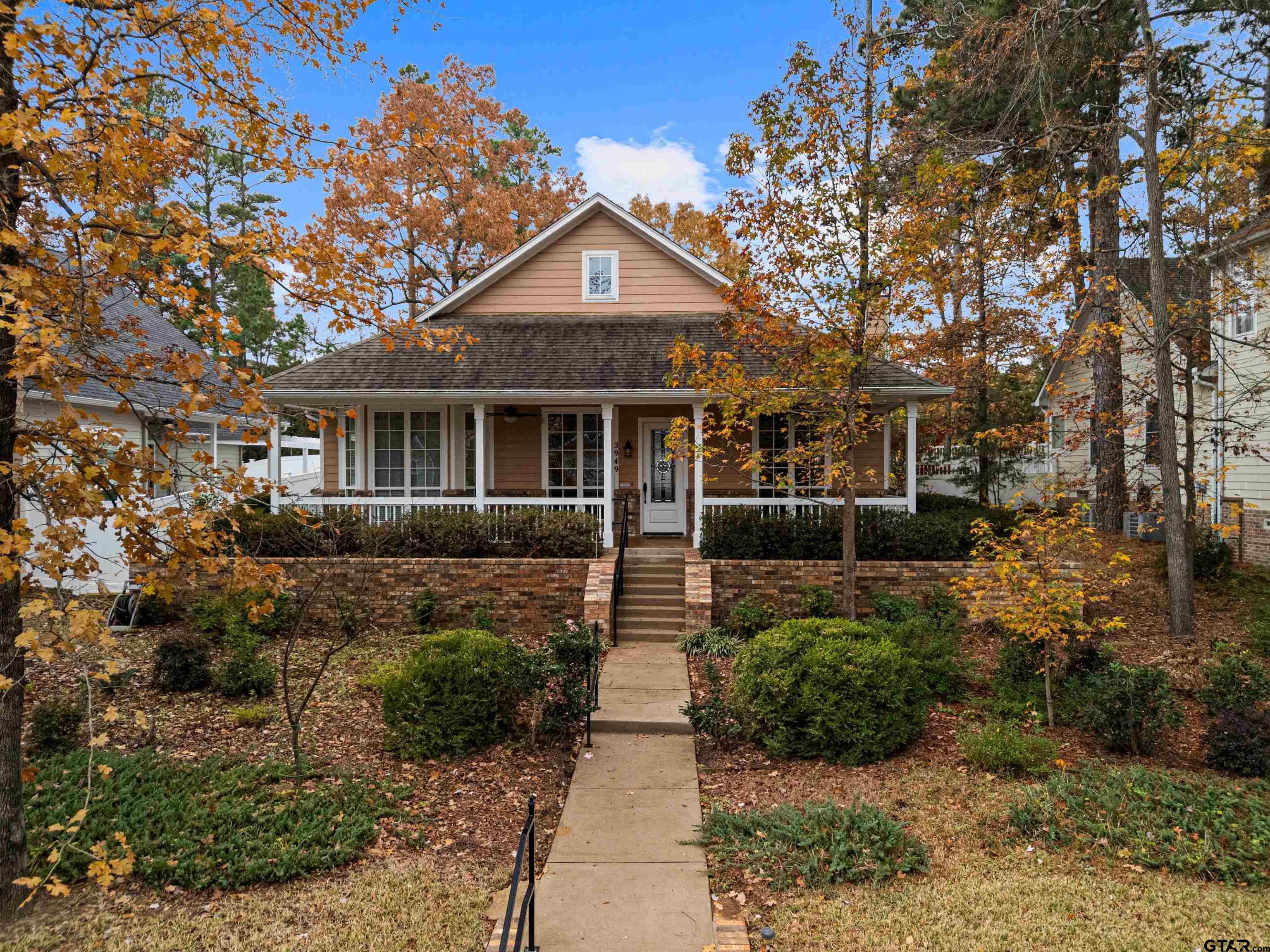 3949 Hanover Place Tyler, TX 75701 - Photo 1 of 43 a front view of a house with a yard and potted plants