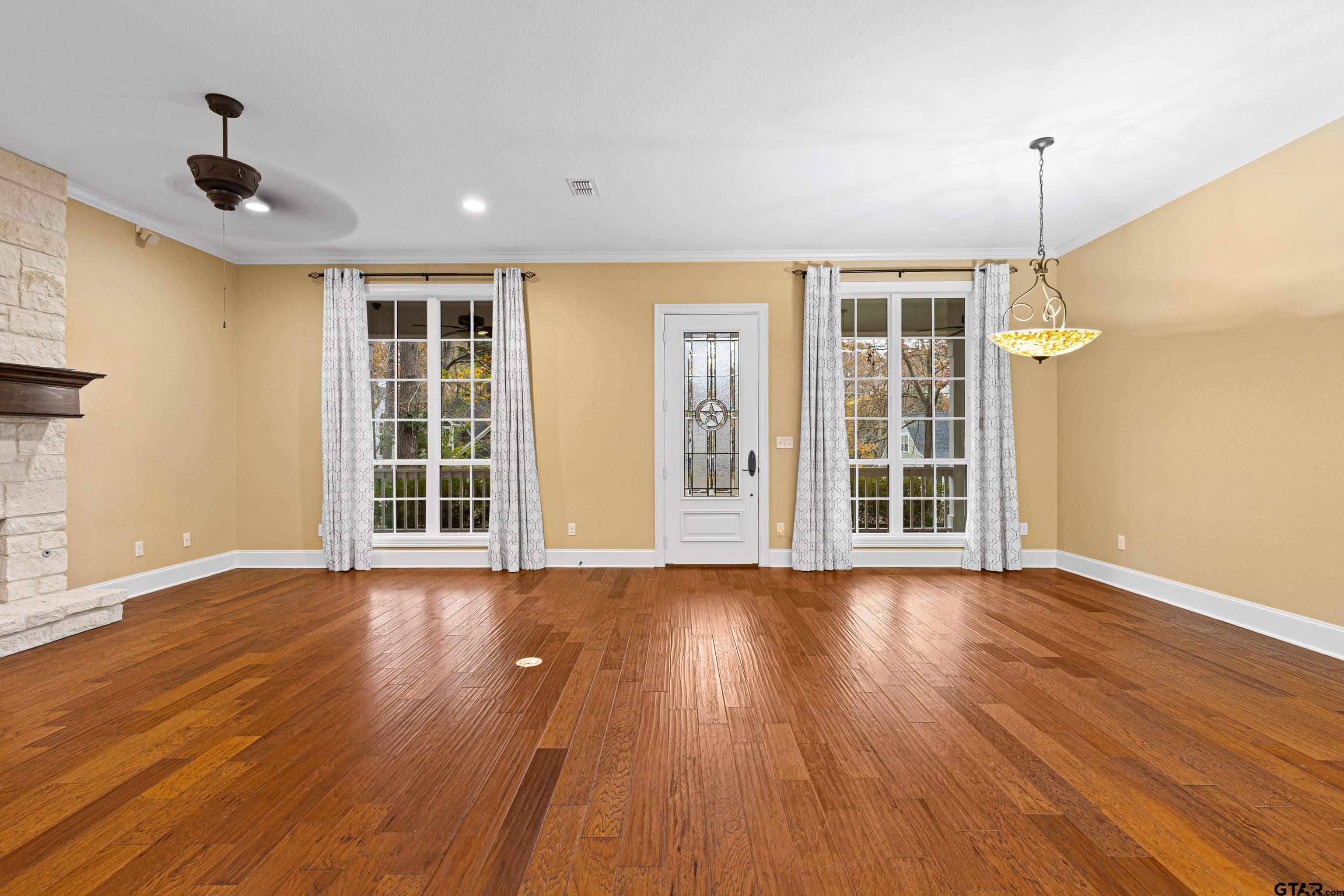 3949 Hanover Place Tyler, TX 75701 - Photo 12 of 43 a view of an empty room with wooden floor and a window