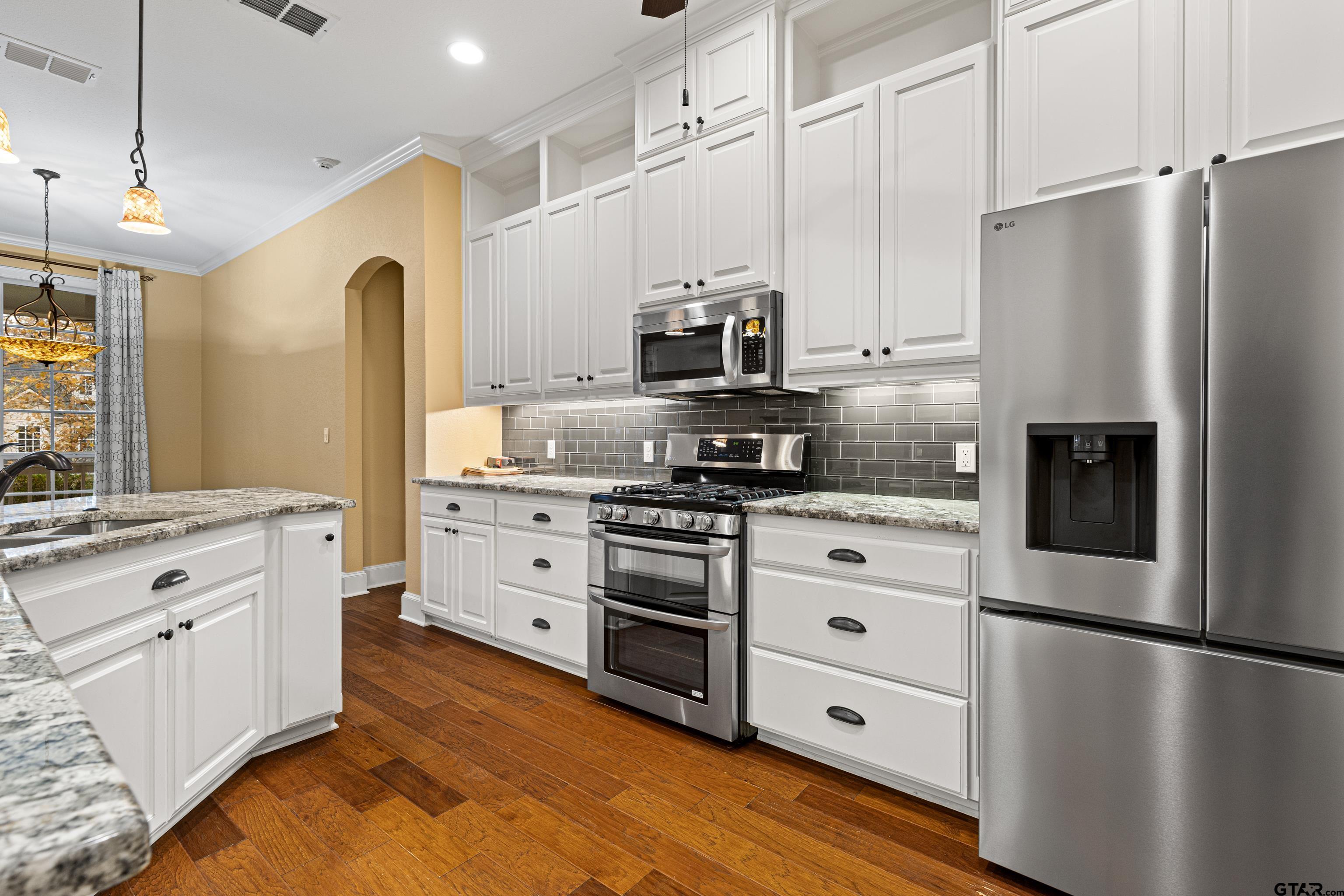 3949 Hanover Place Tyler, TX 75701 - Photo 17 of 43 a kitchen with stainless steel appliances a refrigerator sink and cabinets