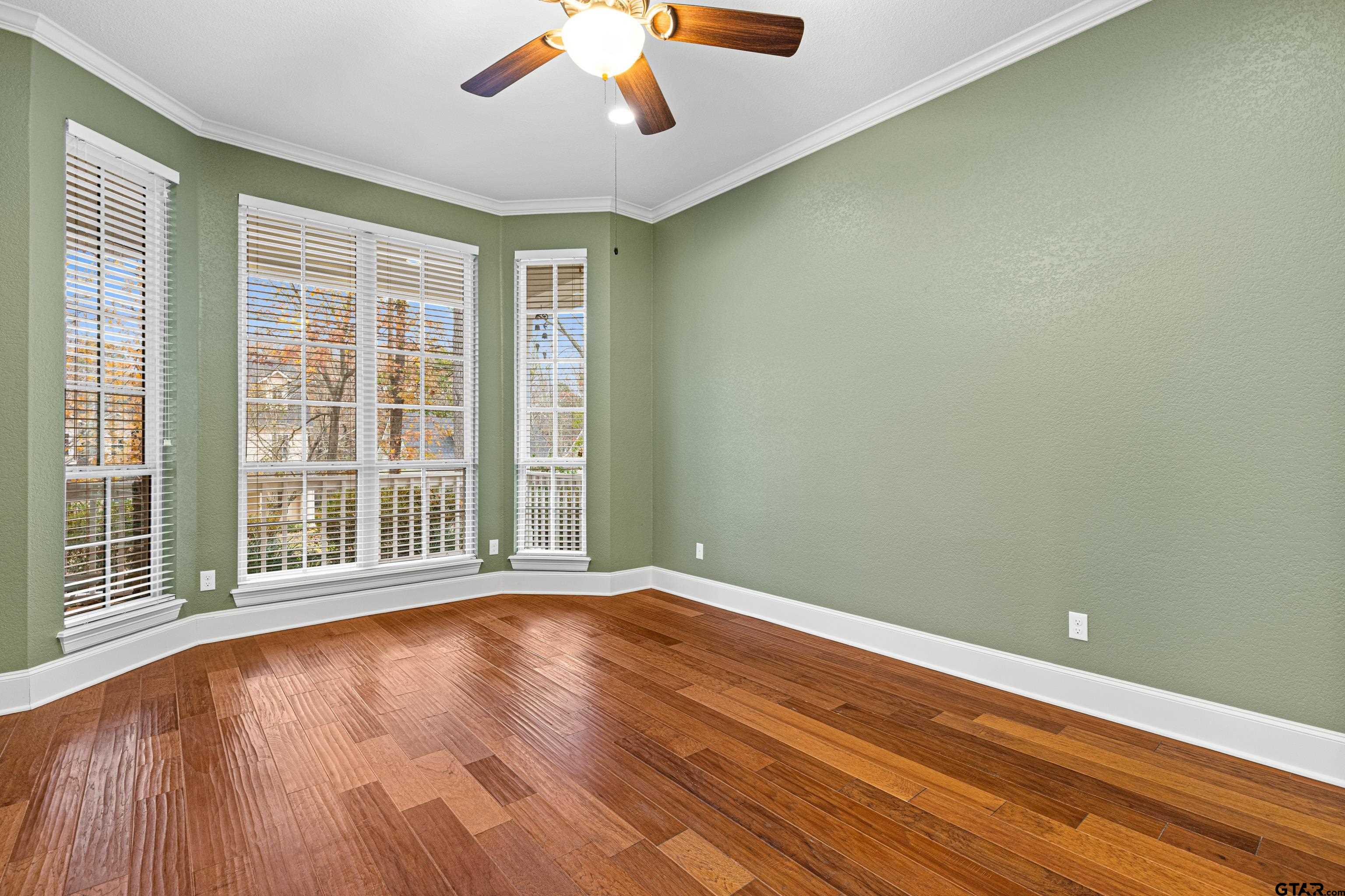 3949 Hanover Place Tyler, TX 75701 - Photo 21 of 43 a view of an empty room with wooden floor and a window