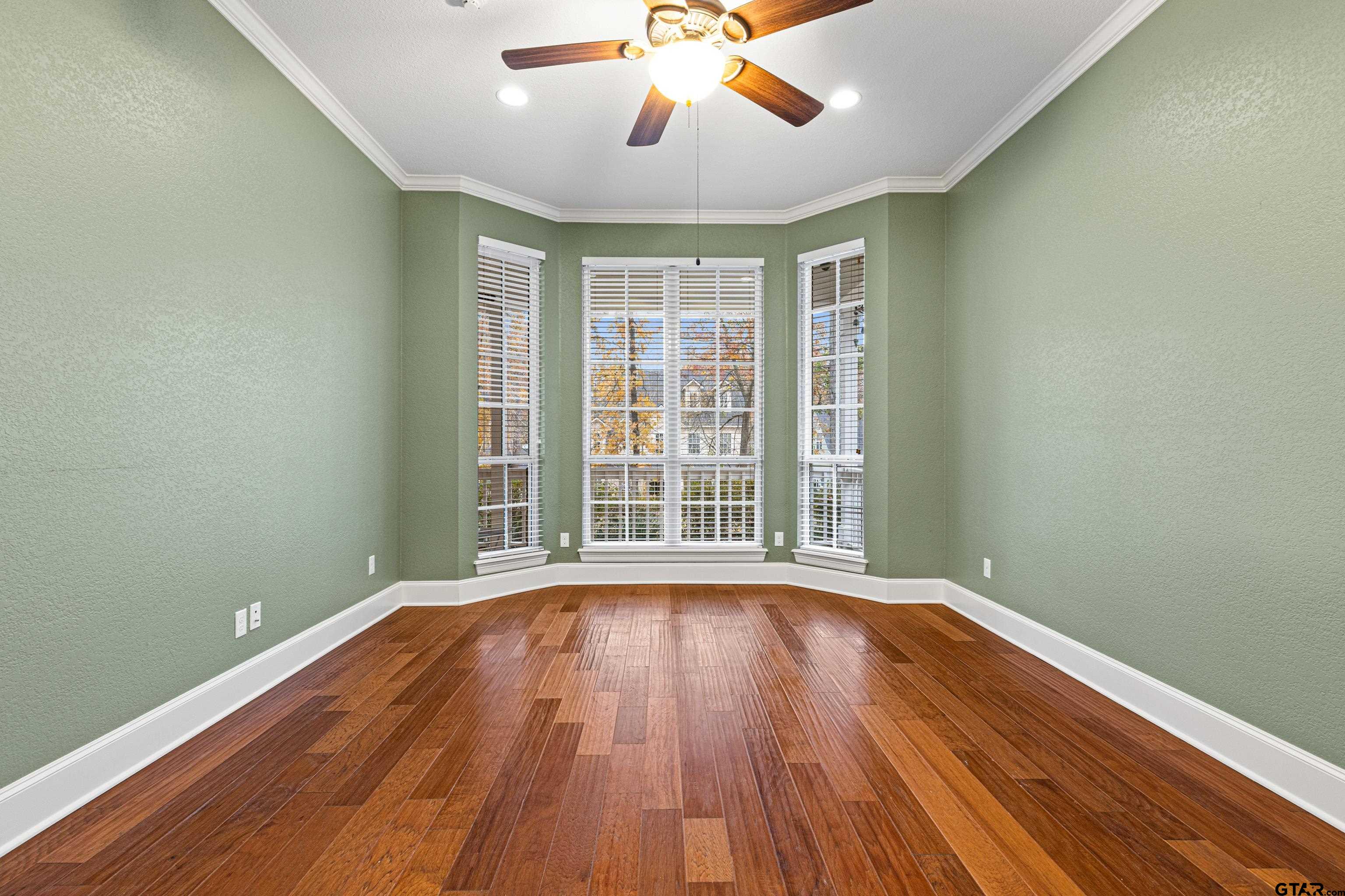 3949 Hanover Place Tyler, TX 75701 - Photo 22 of 43 a view of an empty room with wooden floor and a window
