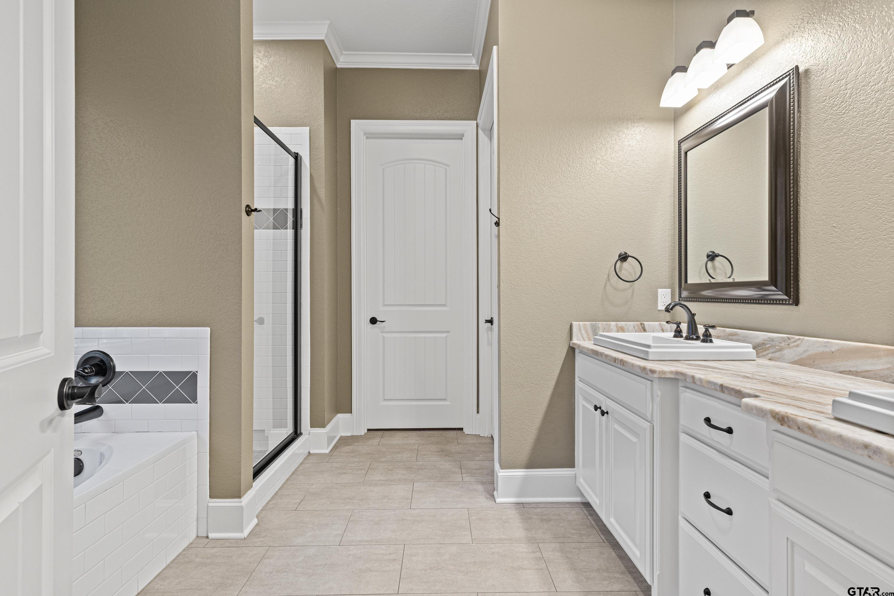 3949 Hanover Place Tyler, TX 75701 - Photo 24 of 43 a bathroom with a double vanity sink mirror and bathtub