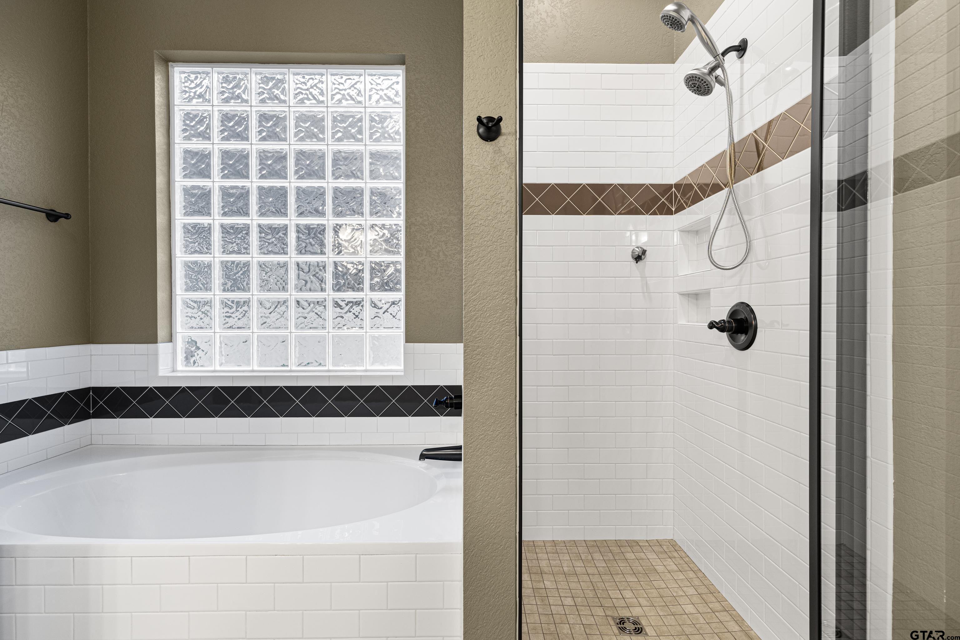 3949 Hanover Place Tyler, TX 75701 - Photo 27 of 43 a bathroom with a bathtub and shower