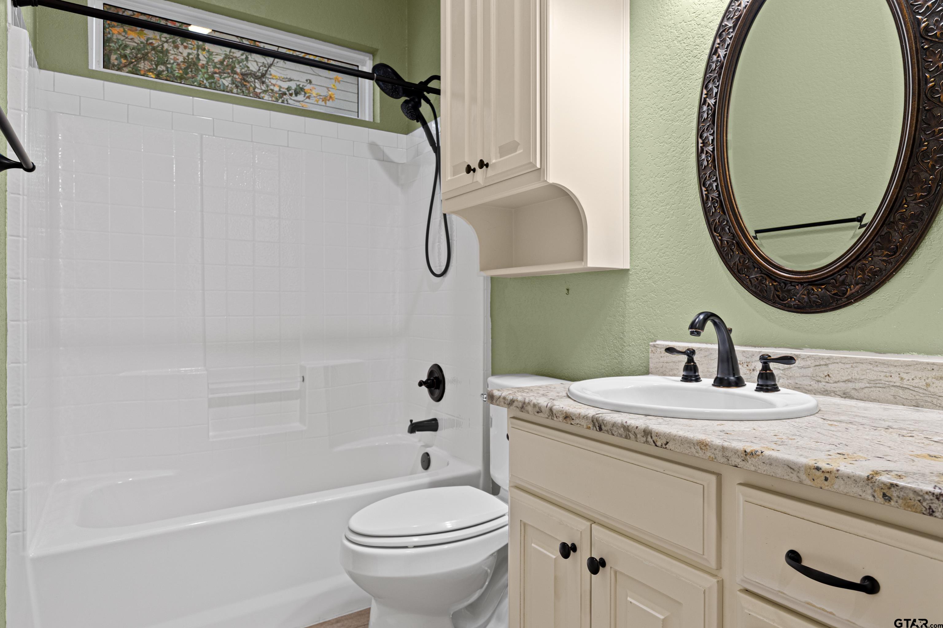 3949 Hanover Place Tyler, TX 75701 - Photo 30 of 43 a bathroom with a sink a toilet and a mirror