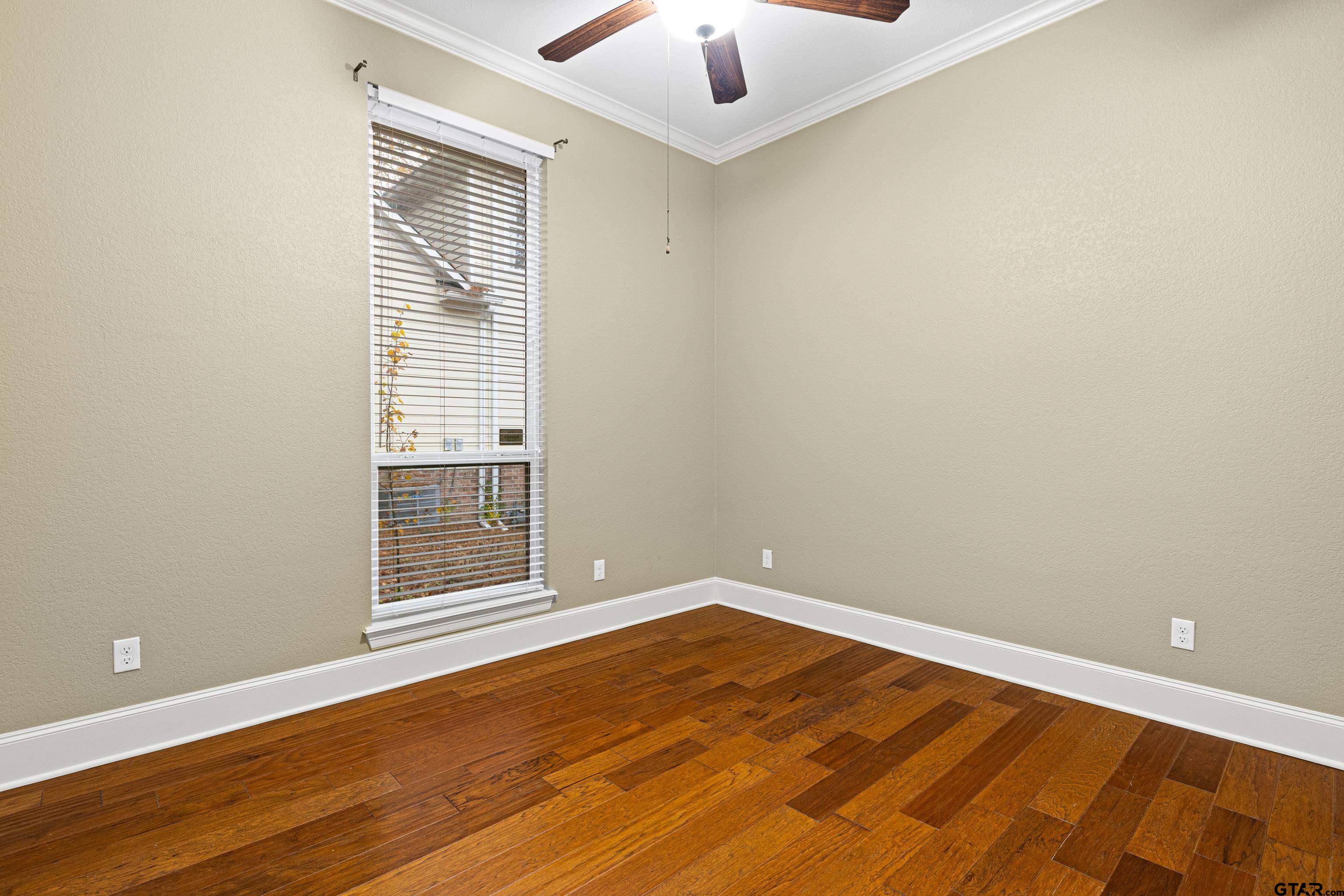 3949 Hanover Place Tyler, TX 75701 - Photo 31 of 43 an empty room with wooden floor and windows
