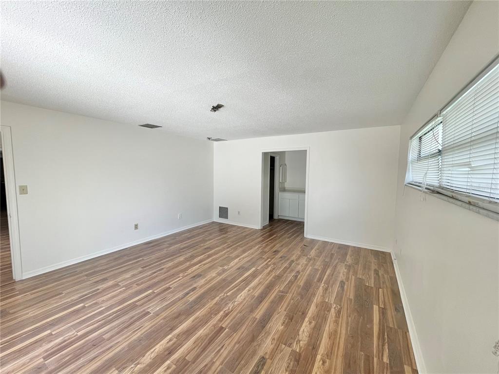 5912 Altec Road Orlando, FL 32808 - Photo 16 of 33 a view of empty room with wooden floor