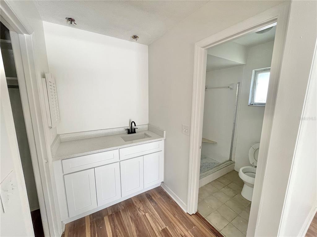 5912 Altec Road Orlando, FL 32808 - Photo 17 of 33 a bathroom with a sink and a mirror