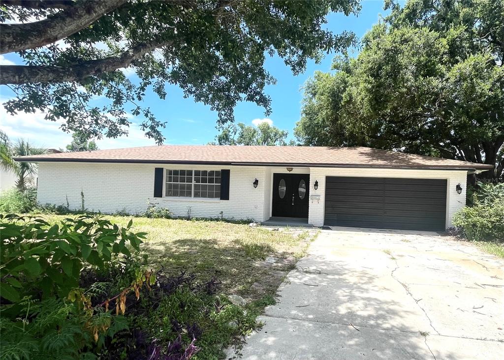 5912 Altec Road Orlando, FL 32808 - Photo 2 of 33 a front view of house with yard and trees in the background