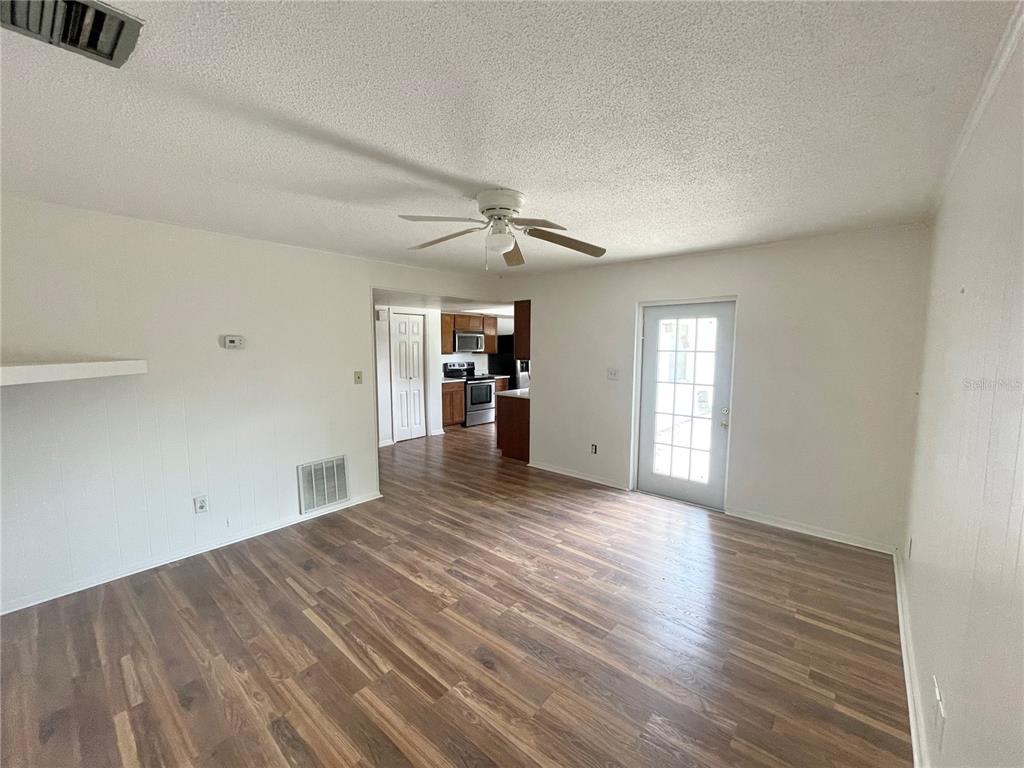 5912 Altec Road Orlando, FL 32808 - Photo 22 of 33 wooden floor in an empty room with a window