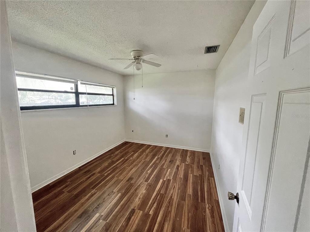 5912 Altec Road Orlando, FL 32808 - Photo 25 of 33 a view of empty room with wooden floor