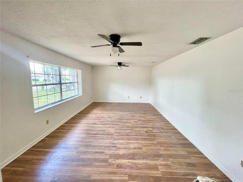 5912 Altec Road Orlando, FL 32808 - Photo 7 of 33 wooden floor in an empty room with a window