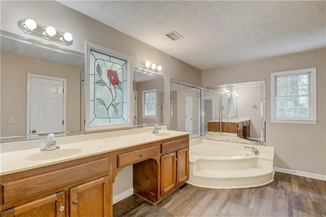 a bathroom with a sink double vanity and a mirror