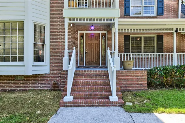 a front view of a house with a garden