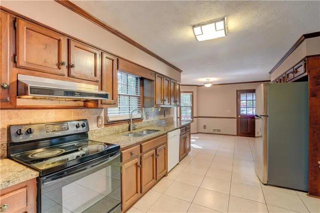 a kitchen with stainless steel appliances granite countertop a stove and a sink