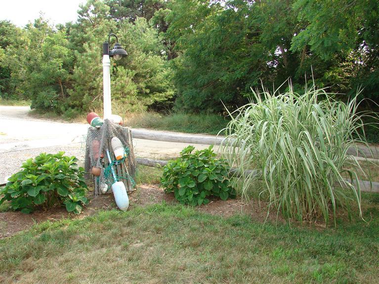 6 Shore Road, Unit 9 Truro, MA 02666 - Photo 16 of 19 a view of a garden with a table and chairs