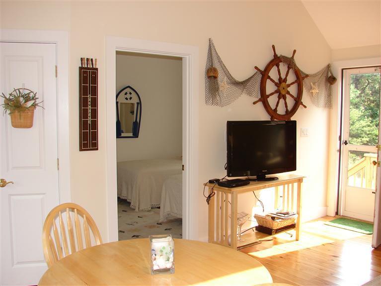 6 Shore Road, Unit 9 Truro, MA 02666 - Photo 2 of 19 a living room with furniture and a flat screen tv