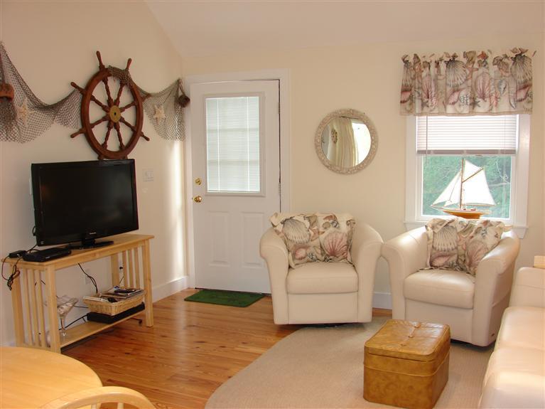 6 Shore Road, Unit 9 Truro, MA 02666 - Photo 3 of 19 a living room with furniture and a flat screen tv