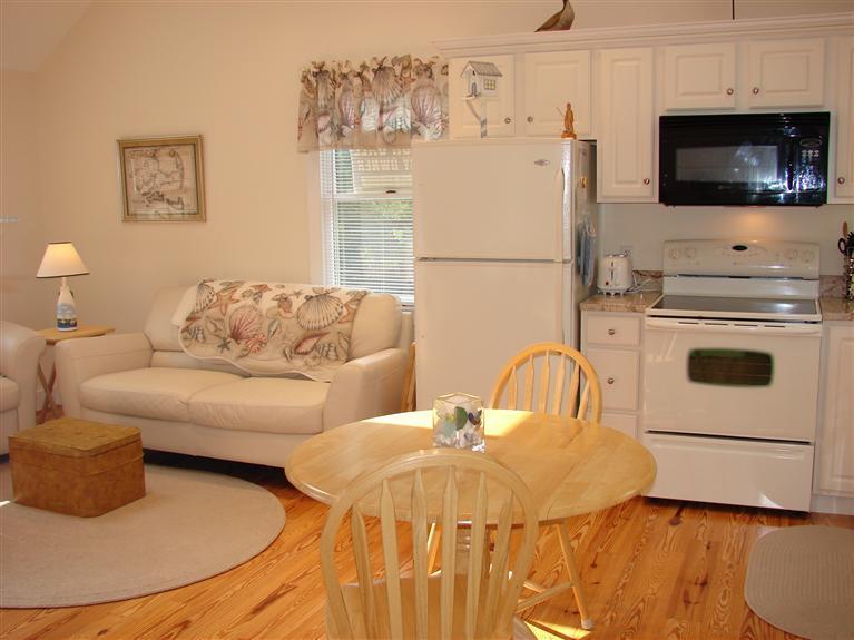 6 Shore Road, Unit 9 Truro, MA 02666 - Photo 6 of 19 a living room with furniture and a flat screen tv