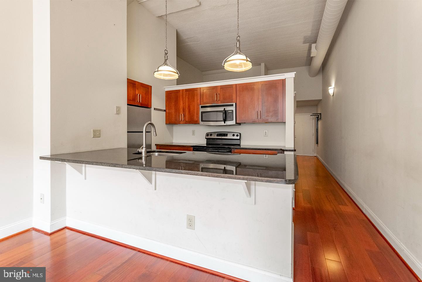 2429 Locust Street, Unit 513 Philadelphia, PA 19103 - Photo 1 of 11 a kitchen with stainless steel appliances granite countertop a sink a stove and a refrigerator