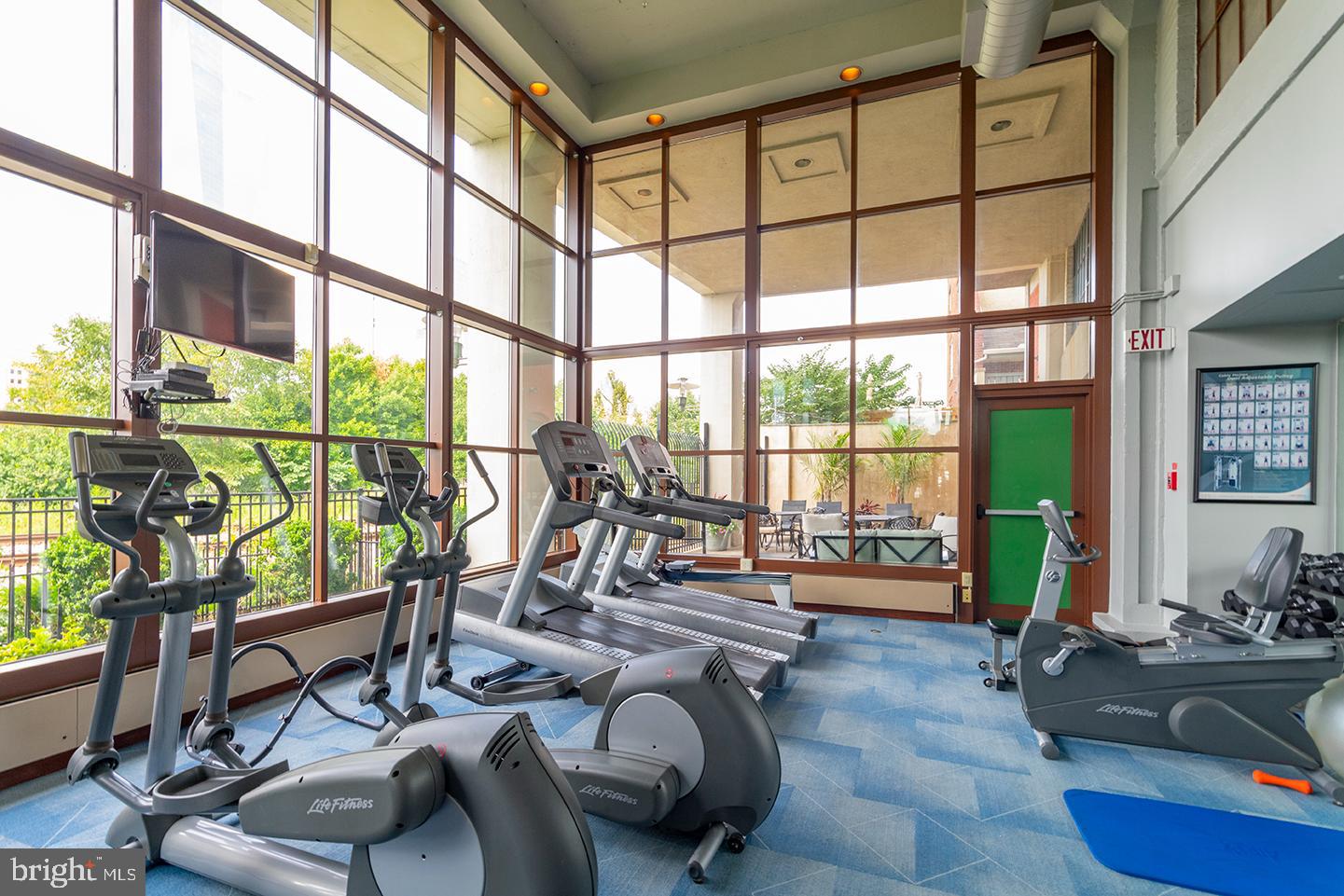 2429 Locust Street, Unit 513 Philadelphia, PA 19103 - Photo 8 of 11 a living room with furniture and floor to ceiling windows
