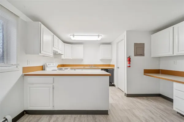 a kitchen with a stove sink and cabinets