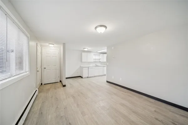 a kitchen with granite countertop white cabinets and white appliances