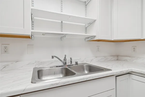 a kitchen with a sink a stove and cabinets