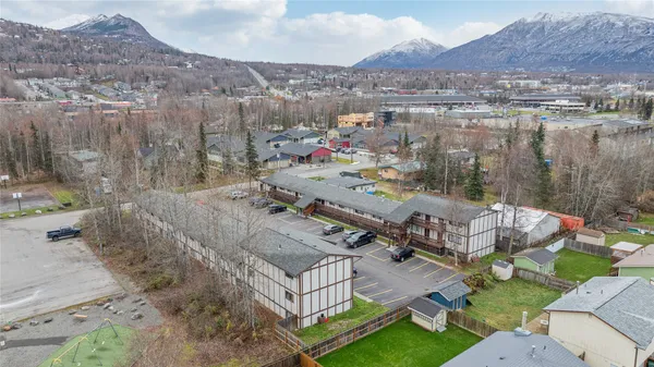 a view of a house with a yard and mountain