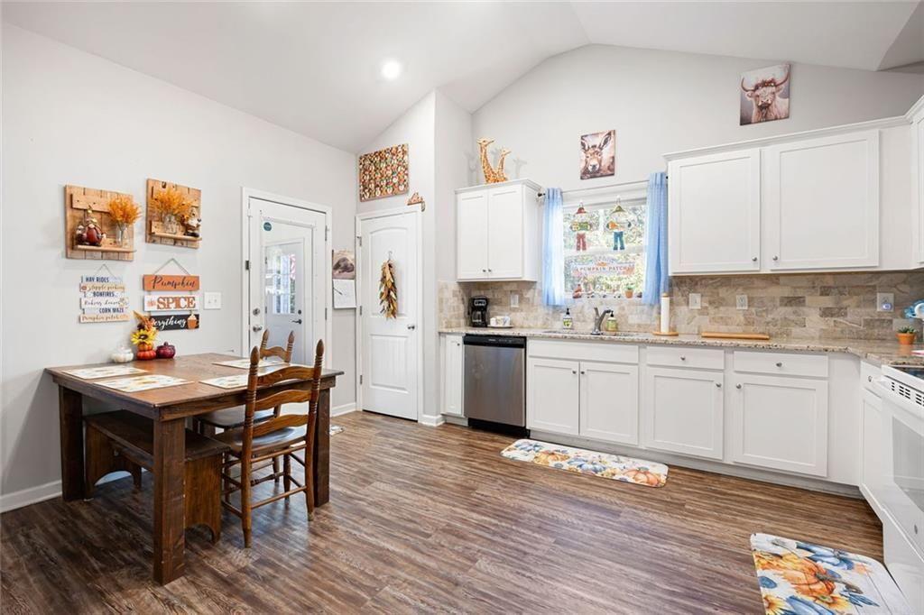 413 River Bluff Drive Temple, GA 30179 - Photo 11 of 30 a kitchen with granite countertop stainless steel appliances a sink and cabinets
