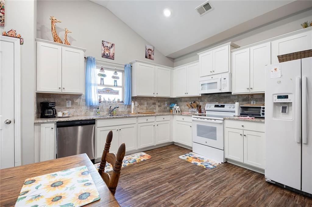 413 River Bluff Drive Temple, GA 30179 - Photo 12 of 30 a kitchen with stainless steel appliances white cabinets a sink and a stove
