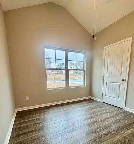 a view of a room with wooden floor