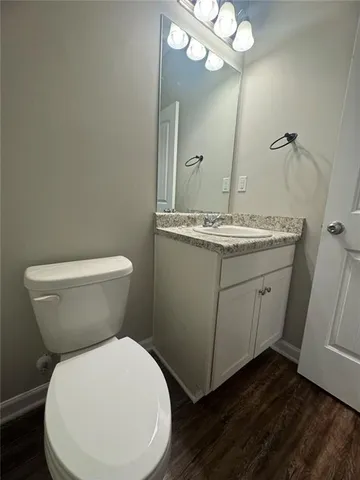 a large tree in front of a house with a yard