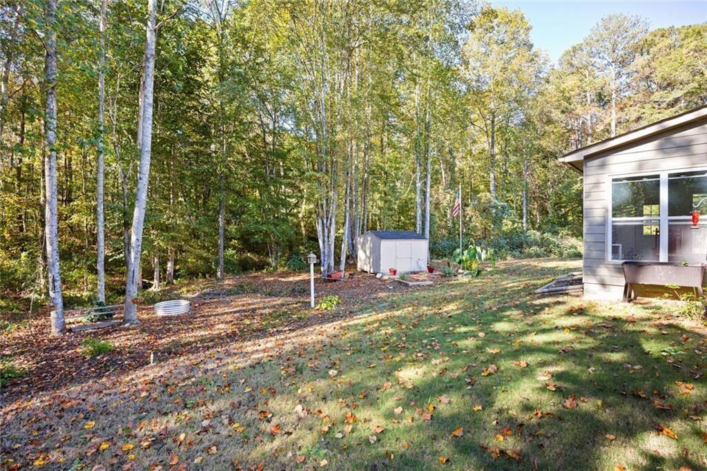 413 River Bluff Drive Temple, GA 30179 - Photo 29 of 30 a backyard of a house with table and chairs