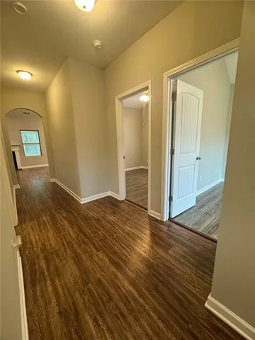 a view of a room with wooden floor and staircase