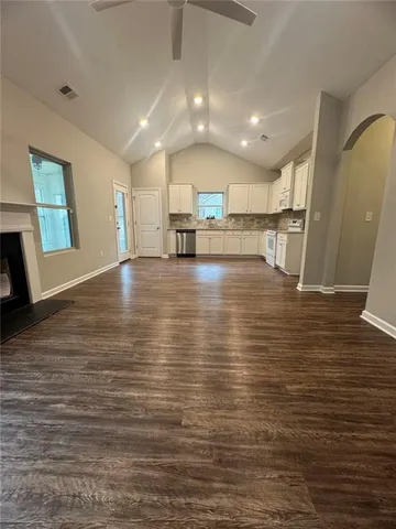 a kitchen with stainless steel appliances wooden cabinets a sink and a stove