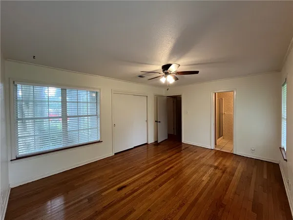 a bathroom with a toilet sink vanity and mirror