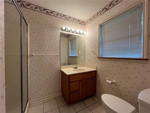 a bathroom with a glass shower door