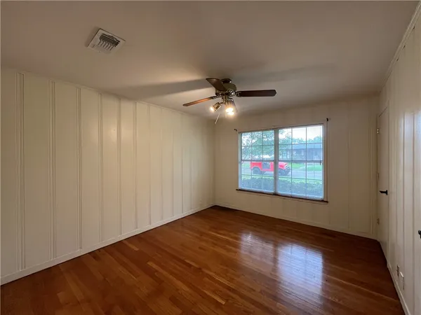 a view of an empty room and wooden floor
