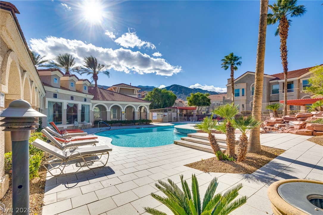 10550 West Alexander Road, Unit 2174 Las Vegas, NV 89129 - Photo 6 of 28 A sparkling community pool is surrounded by palm trees and mountain views.