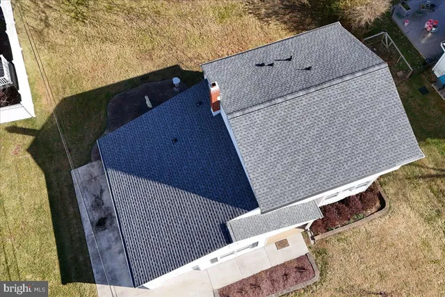 an aerial view of a house with a yard