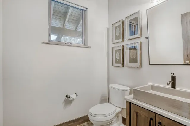 a white toilet sitting next to a bathroom sink