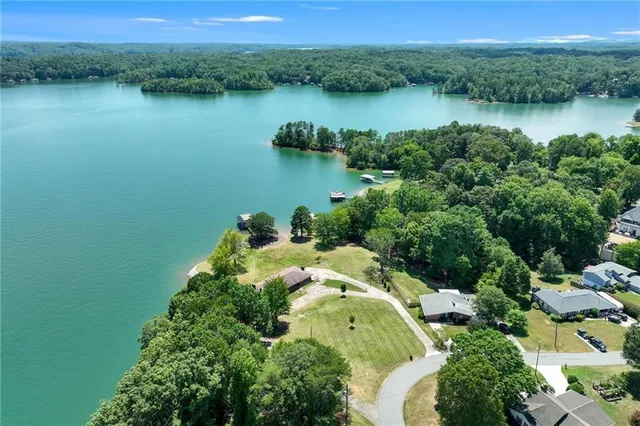 an aerial view of a houses with a lake view
