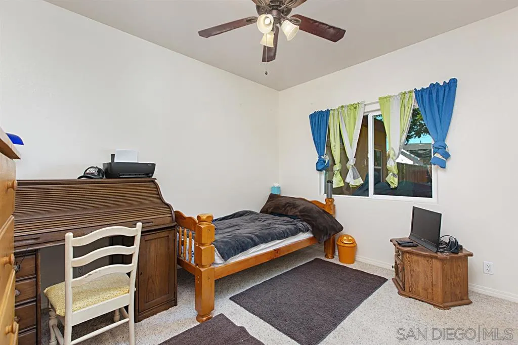 1400 Eucalyptus Drive El Cajon, CA 92021 - Photo 13 of 23 a bedroom with a bed and a window