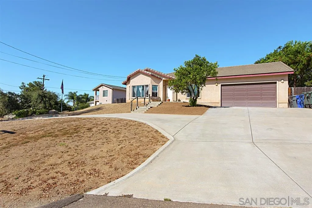 1400 Eucalyptus Drive El Cajon, CA 92021 - Photo 2 of 23 a front view of a house with a yard and garage