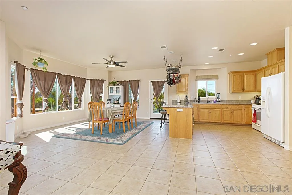 1400 Eucalyptus Drive El Cajon, CA 92021 - Photo 9 of 23 a living room with kitchen island furniture and a chandelier