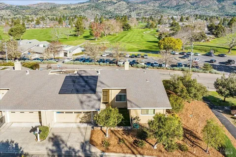 an aerial view of residential houses with outdoor space
