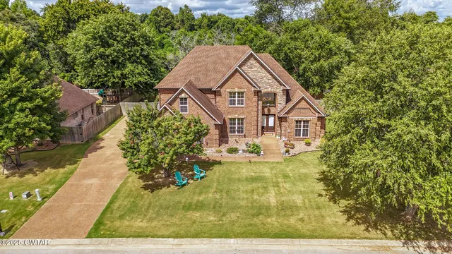 a aerial view of a house with a yard