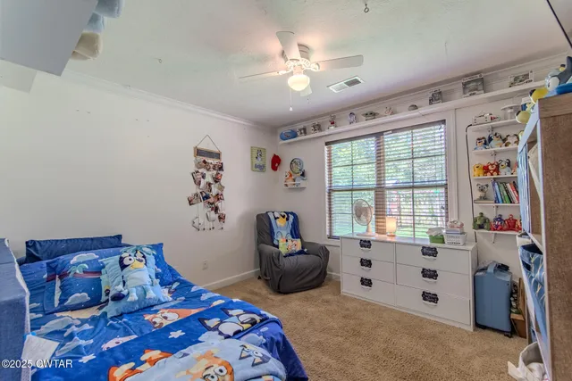 a bedroom with bed and a window